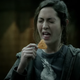 Woman grimacing while about to bite into spicy chip